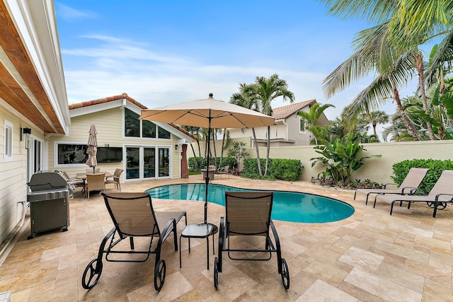 view of pool featuring grilling area and a patio area