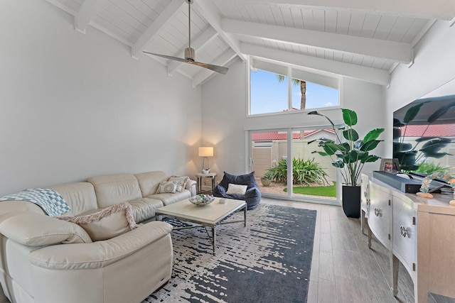 living room with beam ceiling, high vaulted ceiling, and ceiling fan