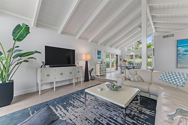 living room featuring beam ceiling and high vaulted ceiling