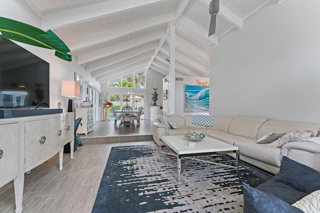 living room with beam ceiling and high vaulted ceiling