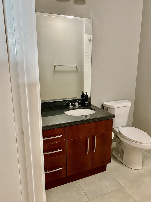 bathroom featuring tile patterned flooring, vanity, and toilet