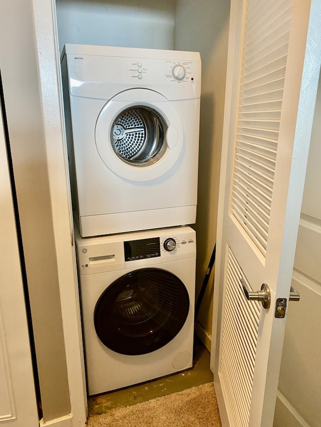 clothes washing area with stacked washer / drying machine