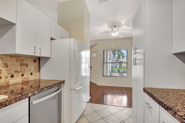 kitchen with light tile patterned floors, dishwasher, ceiling fan, backsplash, and white cabinets