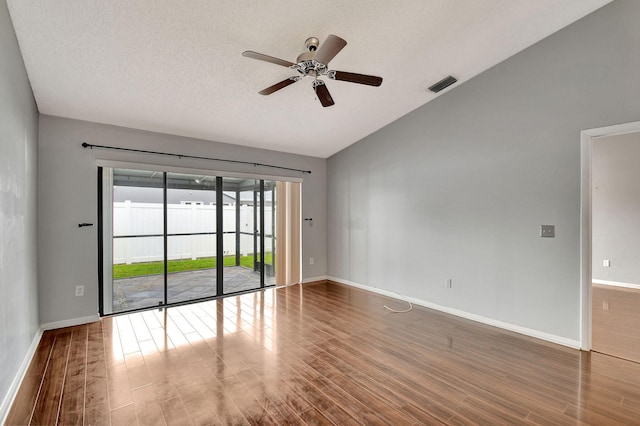 unfurnished room featuring wood-type flooring, lofted ceiling, and ceiling fan