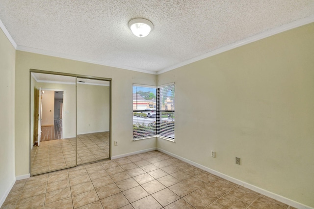 unfurnished bedroom with light tile patterned floors, crown molding, a closet, and a textured ceiling