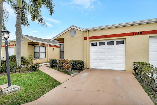 ranch-style home with a garage and a front yard