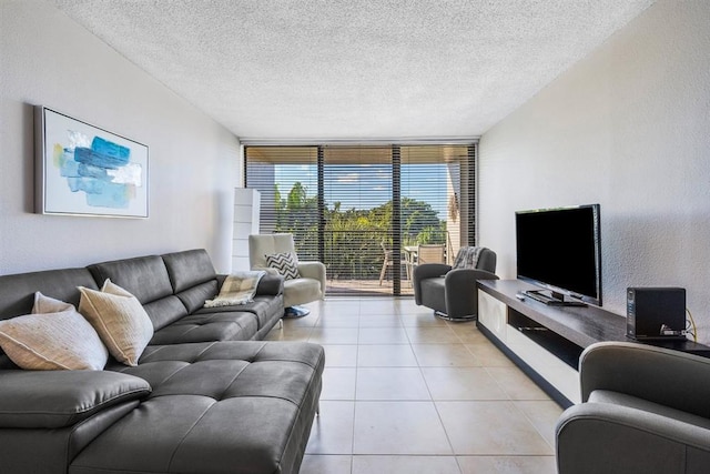 tiled living room featuring expansive windows and a textured ceiling