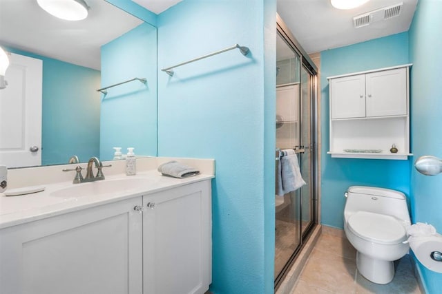 bathroom featuring vanity, walk in shower, tile patterned floors, and toilet