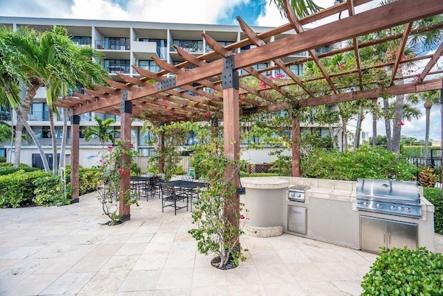 view of patio with a pergola, grilling area, and exterior kitchen