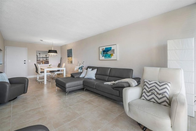 tiled living room featuring a textured ceiling