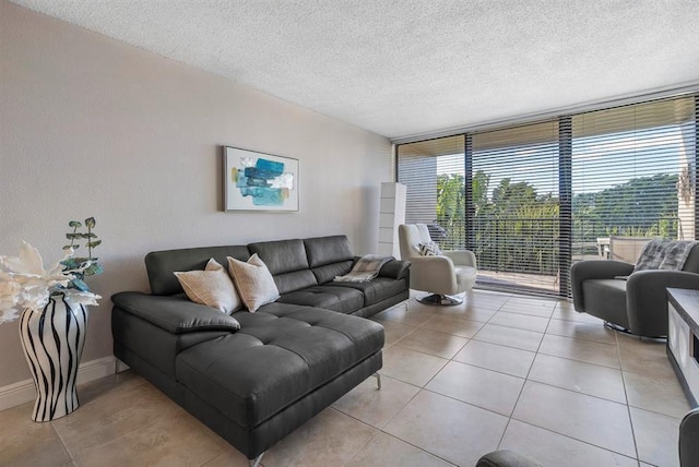 living room featuring light tile patterned floors, expansive windows, and a textured ceiling