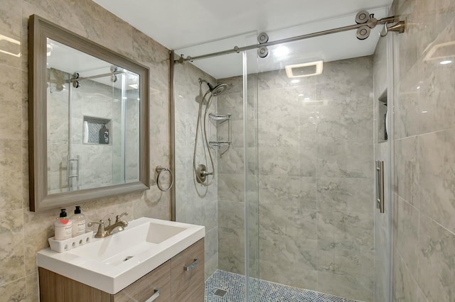 bathroom with vanity and a shower with door