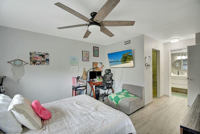 bedroom featuring ceiling fan and ensuite bathroom