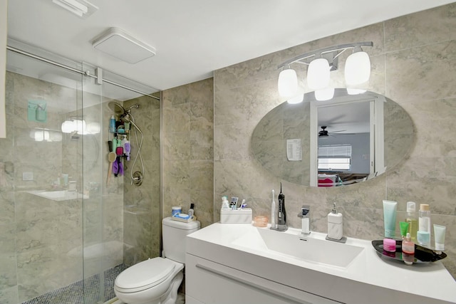 bathroom featuring toilet, a shower with shower door, tile walls, and backsplash