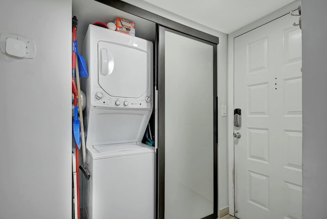 laundry area featuring stacked washing maching and dryer