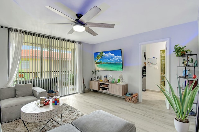 living room featuring ceiling fan and light hardwood / wood-style floors