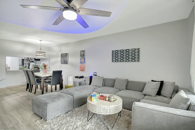 living room featuring light hardwood / wood-style floors and ceiling fan