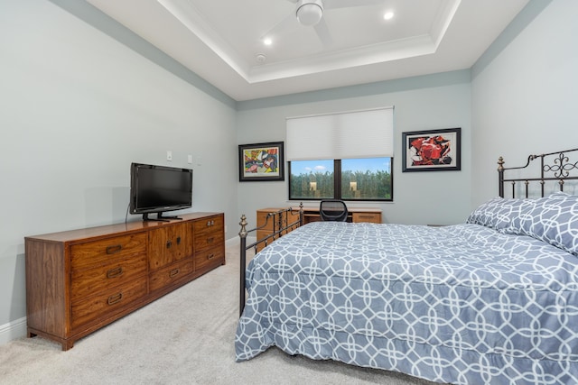 bedroom with ceiling fan, ornamental molding, a raised ceiling, and carpet