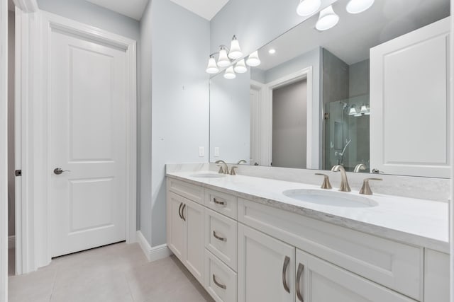 bathroom with an enclosed shower, vanity, and tile patterned floors