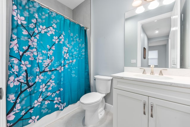 bathroom with tile patterned flooring, vanity, and toilet