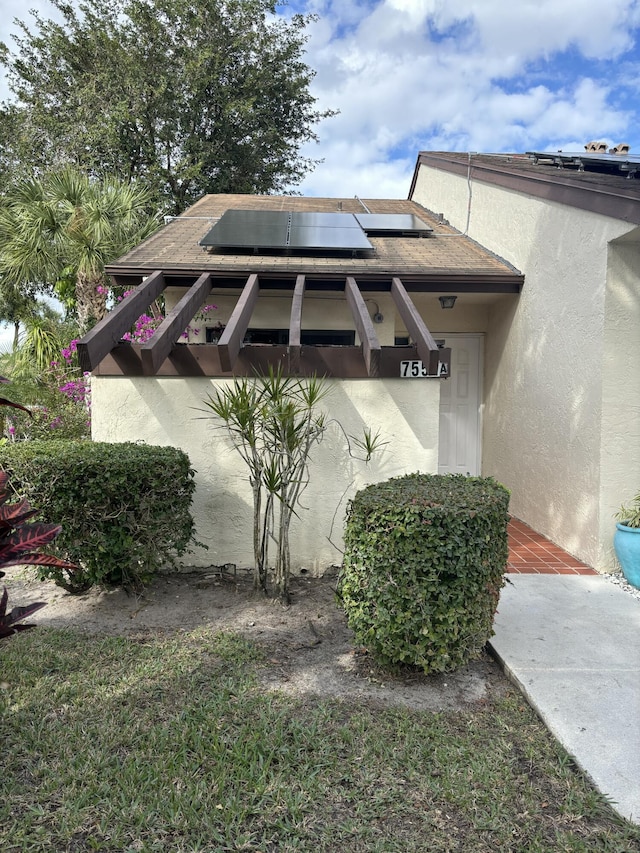 view of side of home with solar panels