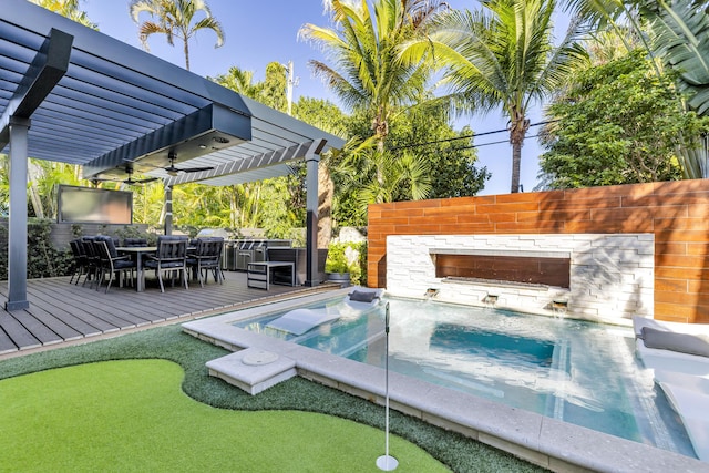 view of swimming pool with a hot tub, pool water feature, a deck, and a pergola