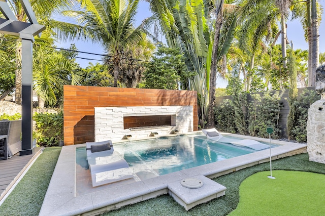 view of swimming pool featuring a hot tub