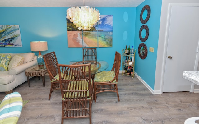 dining area featuring a chandelier and light hardwood / wood-style flooring