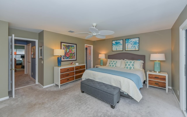 bedroom featuring light carpet, ceiling fan, and a closet