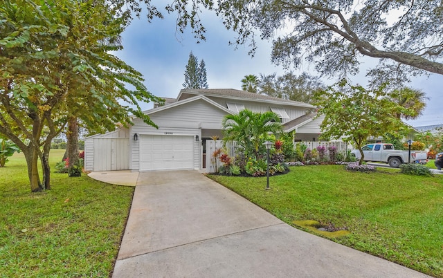 view of front of house with a garage and a front lawn