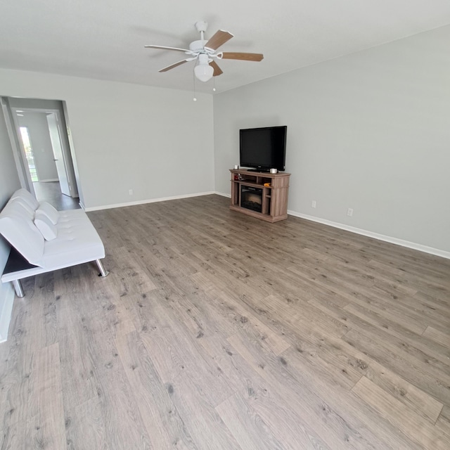 unfurnished living room with ceiling fan and light wood-type flooring