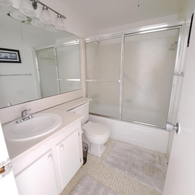 full bathroom featuring enclosed tub / shower combo, tile patterned floors, toilet, and vanity