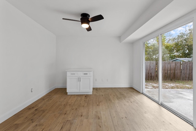 empty room featuring ceiling fan and light hardwood / wood-style floors