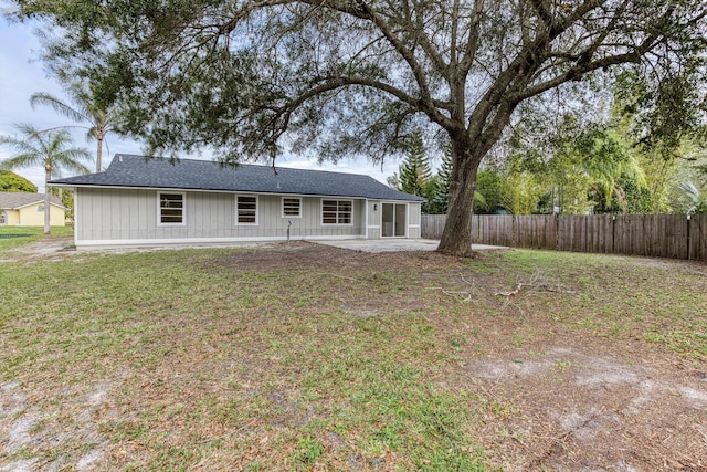 back of property featuring a patio and a lawn