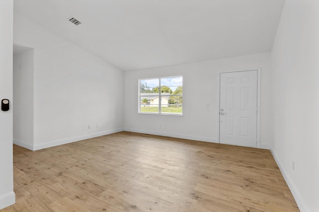 unfurnished room with lofted ceiling and light hardwood / wood-style flooring