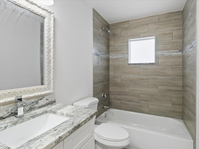 full bathroom featuring tiled shower / bath combo, vanity, and toilet