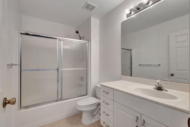 full bathroom with vanity, tile patterned floors, enclosed tub / shower combo, and toilet