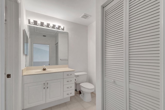 bathroom with vanity, toilet, and tile patterned flooring