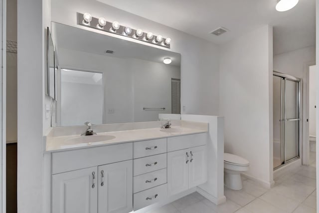 bathroom featuring vanity, toilet, tile patterned floors, and walk in shower