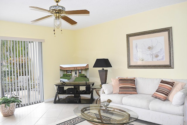 living room with ceiling fan and light tile patterned flooring