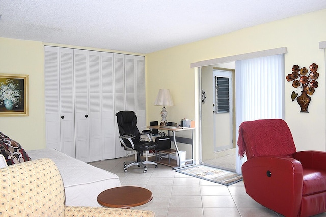 home office with light tile patterned floors and a textured ceiling