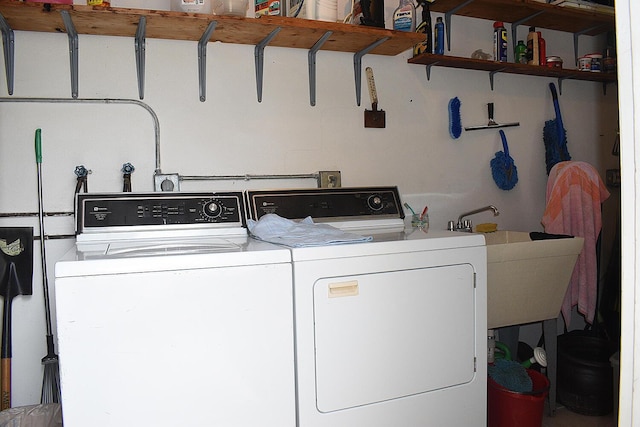 laundry room featuring washing machine and dryer and sink