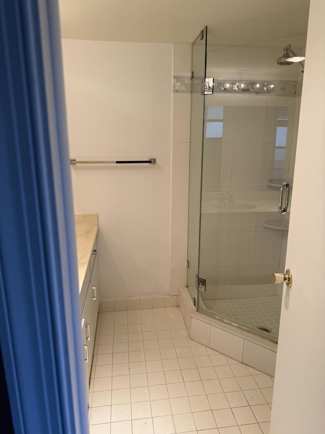 full bath featuring a stall shower, tile patterned flooring, and vanity