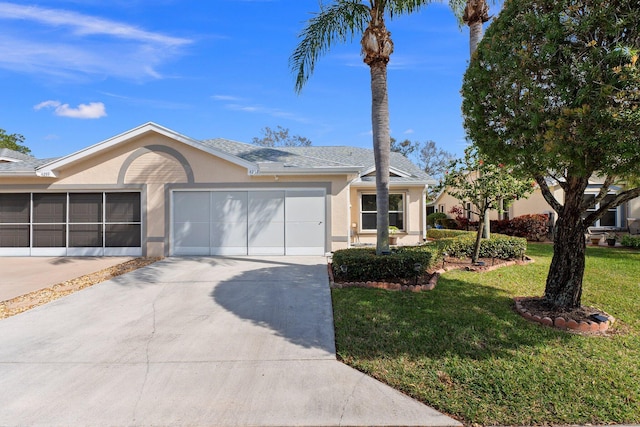 ranch-style house featuring a garage and a front lawn