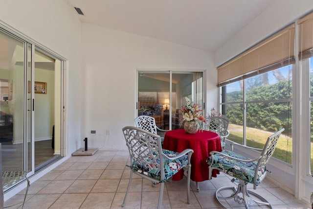 sunroom / solarium featuring lofted ceiling