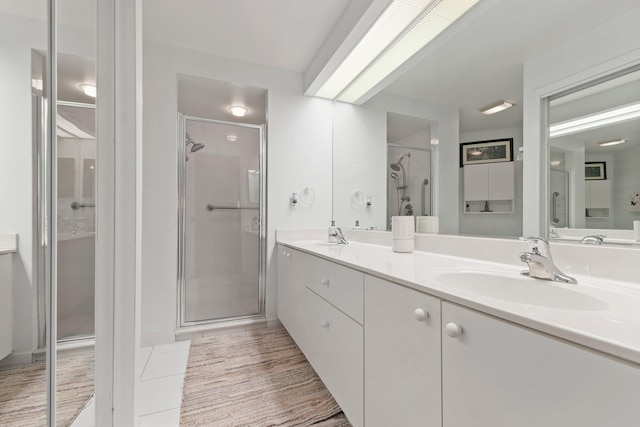 bathroom featuring tile patterned flooring, vanity, and walk in shower