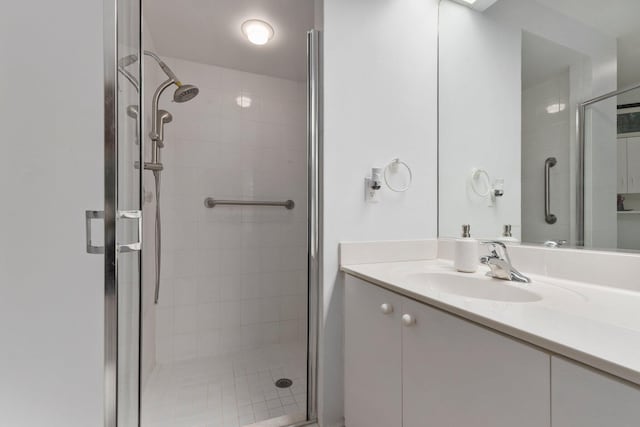 bathroom featuring vanity and an enclosed shower