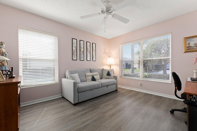 home office with hardwood / wood-style floors, a textured ceiling, and ceiling fan