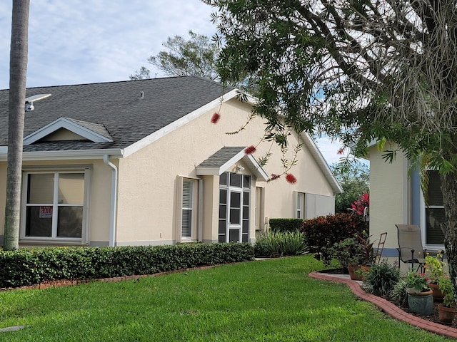 rear view of house featuring a lawn