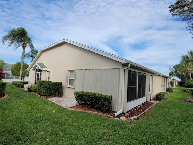 view of side of property with a yard